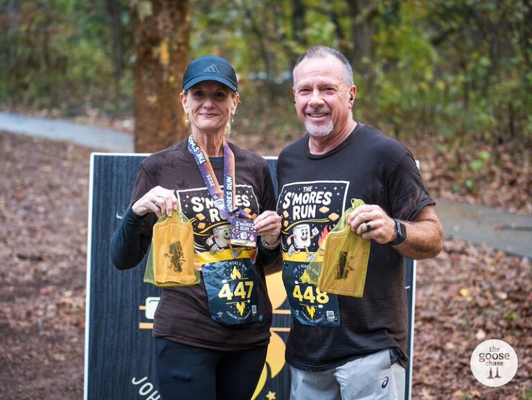 Two Knoxville S'mores Run award recipients displaying medals and prizes