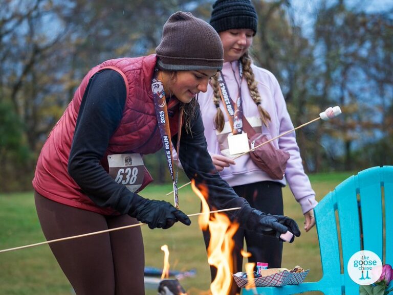 S'mores Run participants toasting marshmallows outdoors at the Knoxville celebration
