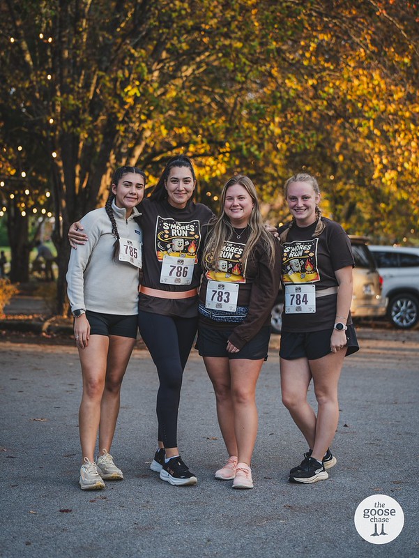 Four runners in The S'mores Run shirts with arms around each other after the race