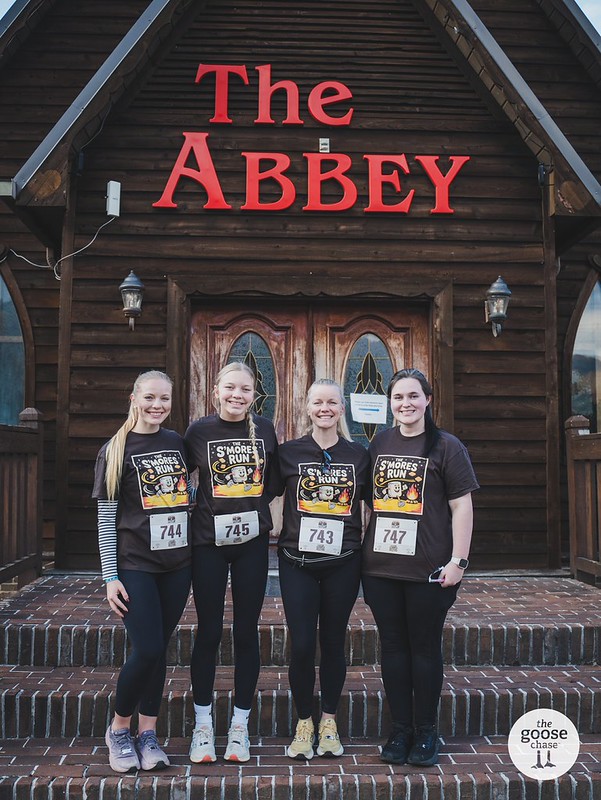 Four participants outside Townsend Abbey after The S'mores Run, with The Goose Chase watermark visible